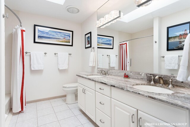 1761 S Shore Dr, Holland, MI 49423 - full bathroom with toilet, a sink, tile patterned floors, and double vanity