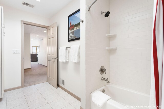 1761 S Shore Dr, Holland, MI 49423 - full bathroom with baseboards, tub / shower combination, visible vents, and tile patterned floors