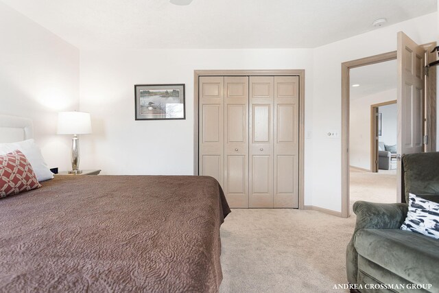 1761 S Shore Dr, Holland, MI 49423 - bedroom featuring baseboards, a closet, and light colored carpet