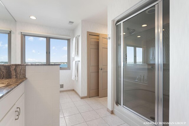 1761 S Shore Dr, Holland, MI 49423 - bathroom featuring tile patterned floors, vanity, a shower stall, baseboards, and visible vents