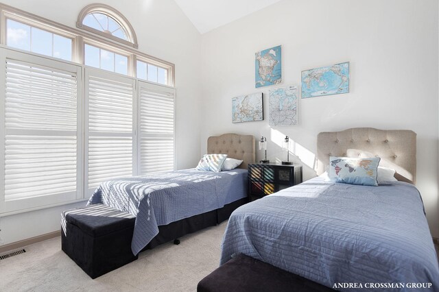 1761 S Shore Dr, Holland, MI 49423 - carpeted bedroom with baseboards, visible vents, and lofted ceiling