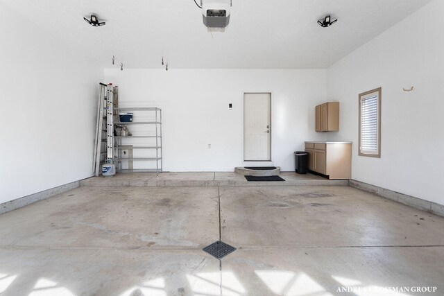 1761 S Shore Dr, Holland, MI 49423 - garage with a garage door opener and baseboards