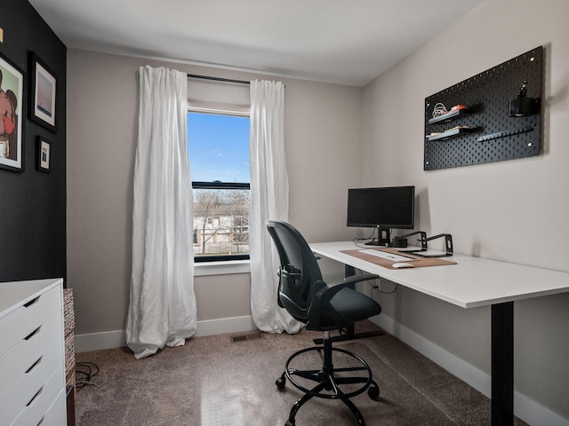 carpeted office space with baseboards and visible vents