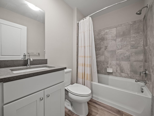 bathroom featuring shower / bathtub combination with curtain, wood finished floors, toilet, and vanity