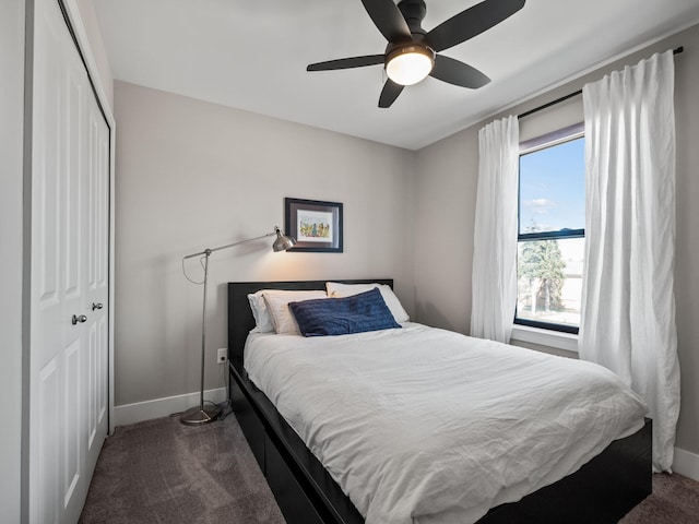 bedroom featuring baseboards, a closet, dark colored carpet, and a ceiling fan