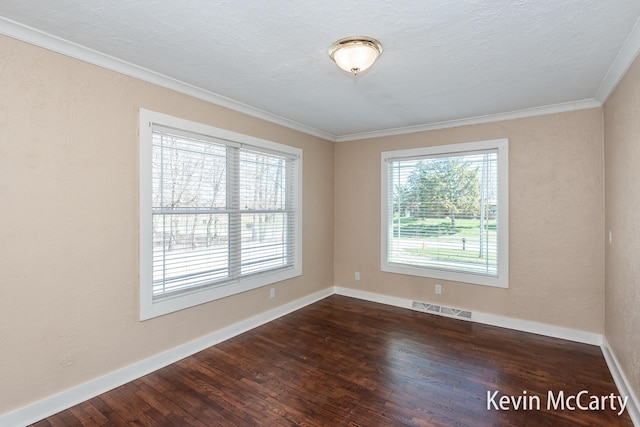 unfurnished room featuring a textured ceiling, dark wood-style floors, baseboards, visible vents, and ornamental molding