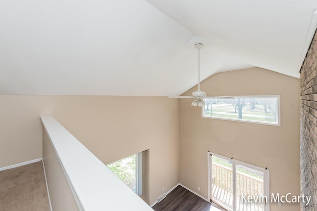 interior space with baseboards and high vaulted ceiling