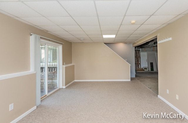 unfurnished room with a drop ceiling, carpet flooring, and baseboards