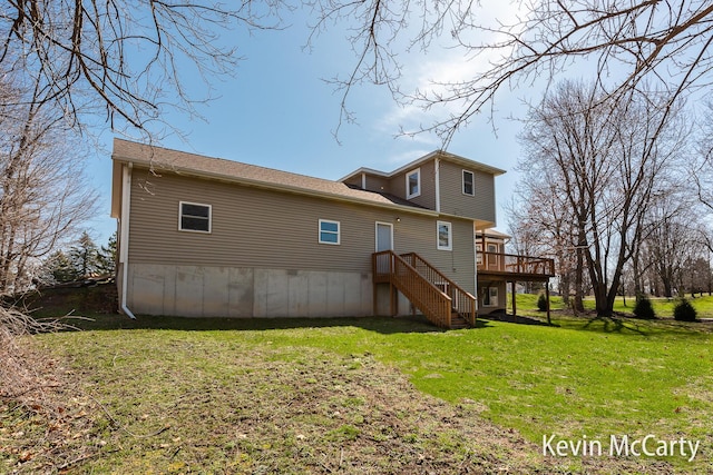 back of house with a lawn, a wooden deck, and stairway