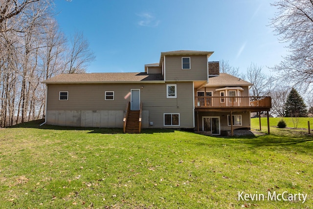 rear view of property featuring a chimney, a deck, and a lawn