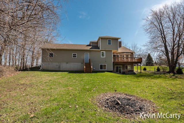 back of property featuring a lawn and a deck
