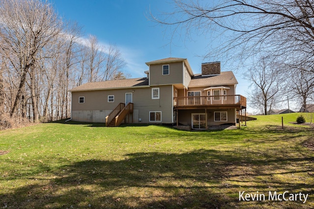 back of property featuring a chimney, a wooden deck, and a yard