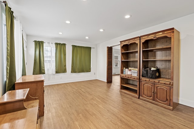 interior space featuring baseboards, light wood-style floors, and recessed lighting