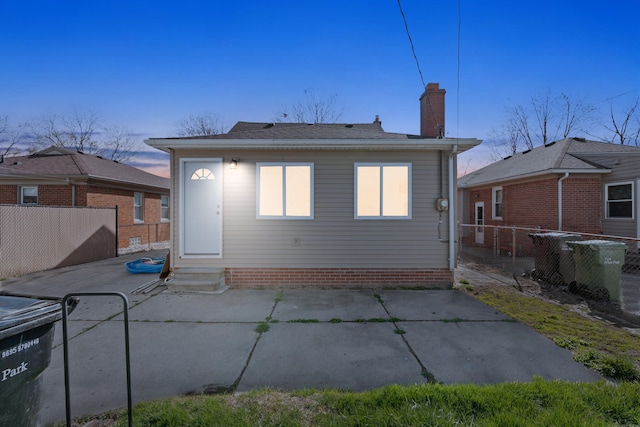 rear view of property with a patio area, a chimney, and fence