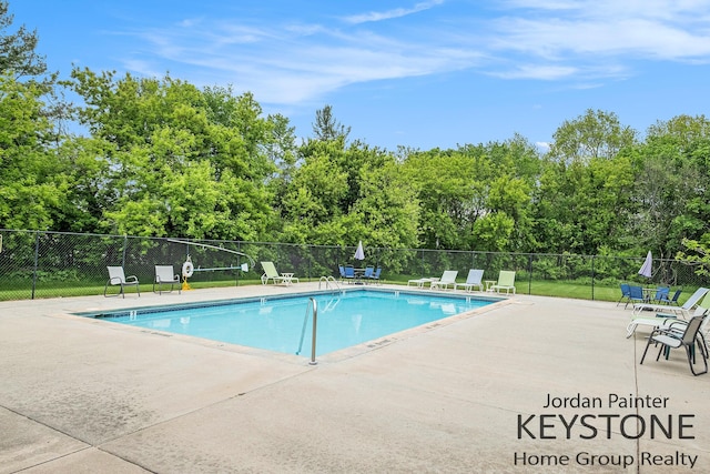 8378 S Jasonville Ct SE Unit 58, Caledonia, MI 49316 - community pool with a patio and view of scattered trees