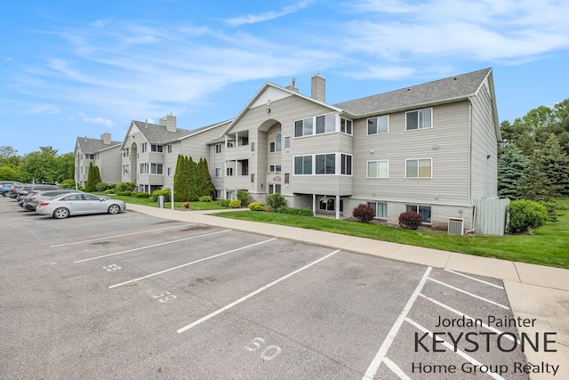 8378 S Jasonville Ct SE Unit 58, Caledonia, MI 49316 - view of property featuring uncovered parking and central AC