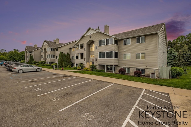 8378 S Jasonville Ct SE Unit 58, Caledonia, MI 49316 - property at dusk featuring central AC and uncovered parking