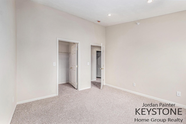 8378 S Jasonville Ct SE Unit 58, Caledonia, MI 49316 - unfurnished bedroom featuring light colored carpet, baseboards, a spacious closet, recessed lighting, and a closet