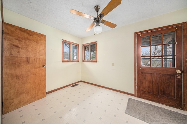 121 Wilkinson St, Chelsea, MI 48118 - entrance foyer featuring baseboards, light floors, a textured ceiling, visible vents, and ceiling fan