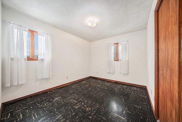 121 Wilkinson St, Chelsea, MI 48118 - spare room with a textured ceiling and baseboards