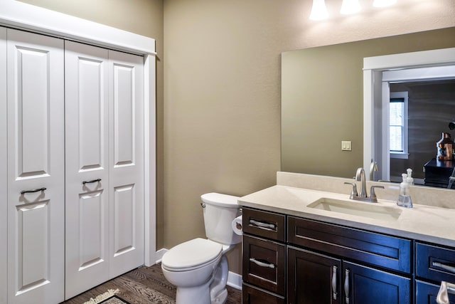 4274 Evergreen Rd Unit 14, Adrian, MI 49221 - bathroom featuring vanity, baseboards, toilet, and wood finished floors