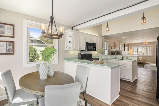 kitchen with light countertops, open shelves, white cabinetry, a peninsula, and black appliances
