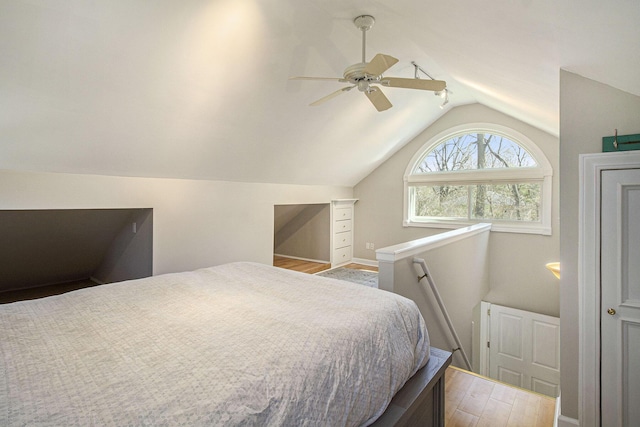 bedroom with vaulted ceiling, wood finished floors, and a ceiling fan