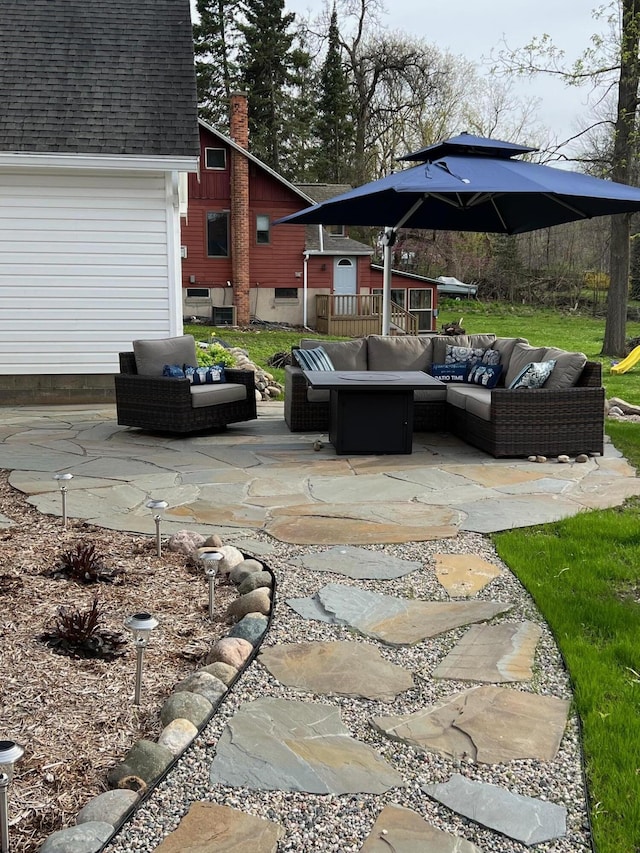 view of patio / terrace featuring an outdoor living space and a garage