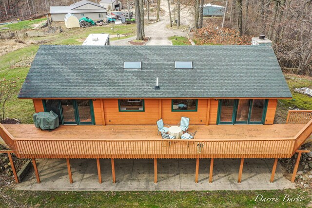 3770 Pine Ln, Saranac, MI 48881 - back of property featuring a wooden deck, a chimney, and a shingled roof