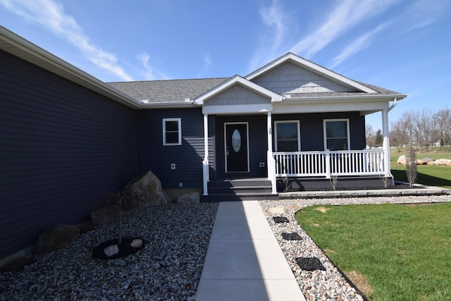 28 Hunting Trail Ave, Quincy, MI 49082 - entrance to property with a porch, a shingled roof, and a lawn