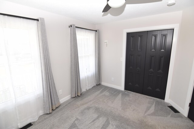 28 Hunting Trail Ave, Quincy, MI 49082 - unfurnished bedroom featuring baseboards, carpet floors, visible vents, a ceiling fan, and a closet
