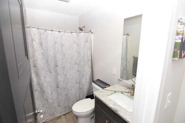28 Hunting Trail Ave, Quincy, MI 49082 - full bathroom with toilet, vanity, a shower with shower curtain, and wood finished floors