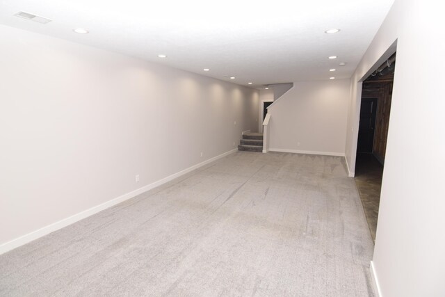 28 Hunting Trail Ave, Quincy, MI 49082 - below grade area featuring visible vents, baseboards, stairs, recessed lighting, and light carpet