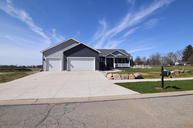 28 Hunting Trail Ave, Quincy, MI 49082 - ranch-style home with covered porch, concrete driveway, a garage, and a front lawn