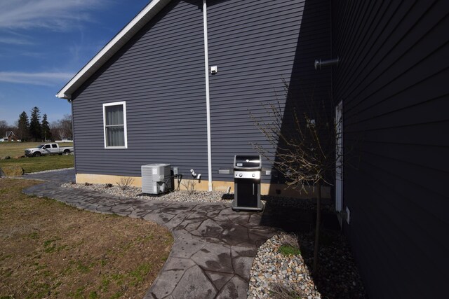 28 Hunting Trail Ave, Quincy, MI 49082 - view of property exterior featuring a patio and central air condition unit