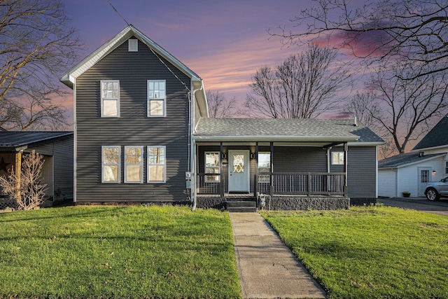 101 E 4th St, Buchanan, MI 49107 - traditional-style house featuring a porch, a shingled roof, and a yard