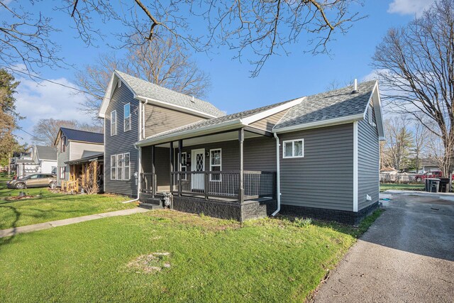 101 E 4th St, Buchanan, MI 49107 - view of property exterior with a lawn, driveway, a porch, and roof with shingles