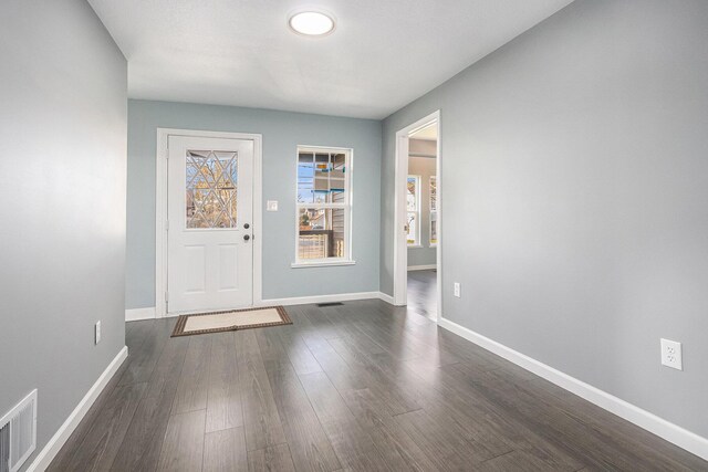 101 E 4th St, Buchanan, MI 49107 - entryway with dark wood-type flooring, baseboards, and visible vents