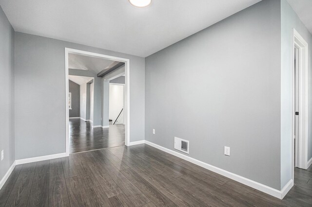 101 E 4th St, Buchanan, MI 49107 - spare room featuring dark wood-style flooring, baseboards, and visible vents