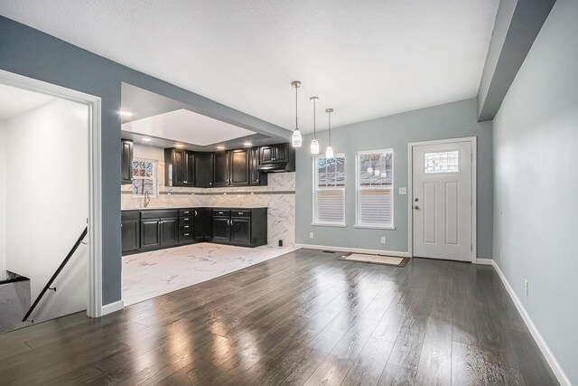 101 E 4th St, Buchanan, MI 49107 - interior space with baseboards, wood finished floors, and a sink