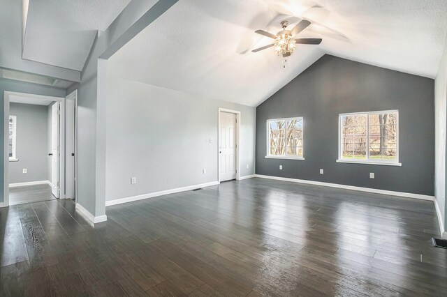 101 E 4th St, Buchanan, MI 49107 - empty room featuring baseboards, dark wood-style flooring, vaulted ceiling, and a ceiling fan