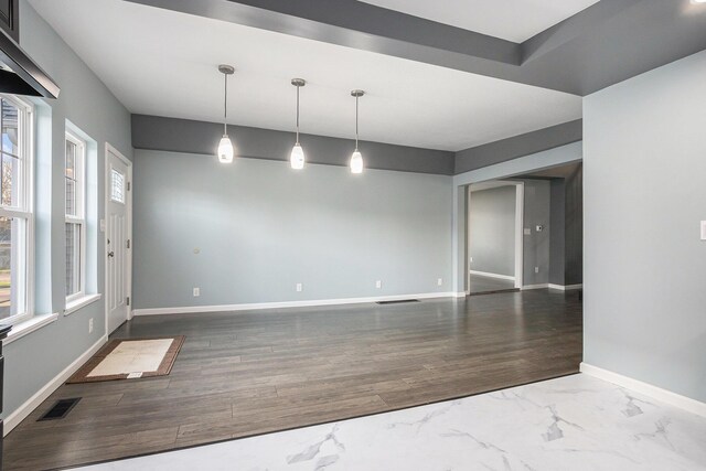 101 E 4th St, Buchanan, MI 49107 - empty room with wood finished floors, baseboards, and visible vents