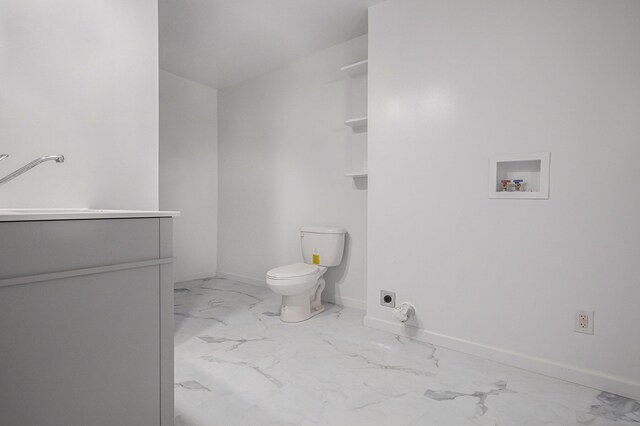 101 E 4th St, Buchanan, MI 49107 - bathroom with marble finish floor, baseboards, toilet, and vanity