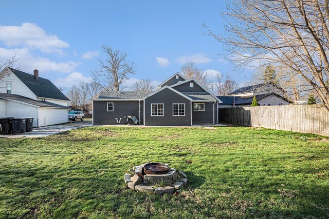 101 E 4th St, Buchanan, MI 49107 - rear view of property with a patio, an outdoor fire pit, a lawn, and fence