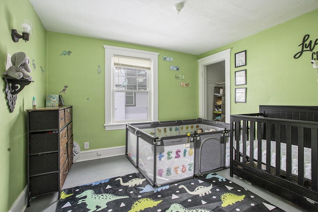 bedroom featuring baseboards and a textured ceiling