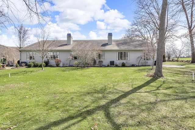4284 Fairway Ln, Jackson, MI 49201 - rear view of house with a yard, a shingled roof, and a chimney