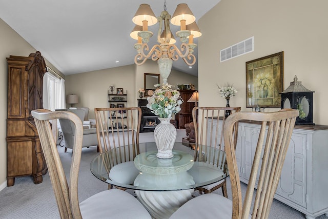 4284 Fairway Ln, Jackson, MI 49201 - dining area featuring a notable chandelier, visible vents, light colored carpet, and vaulted ceiling
