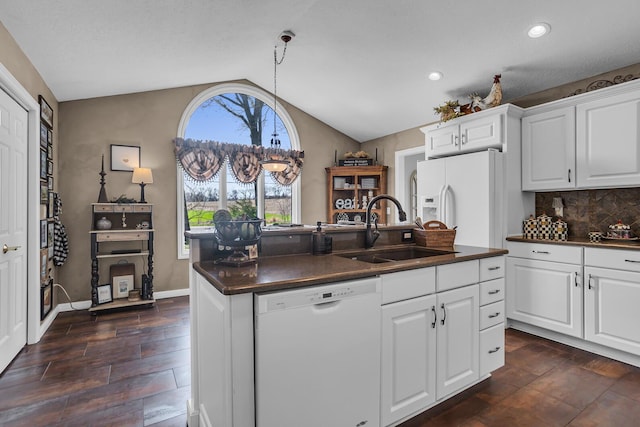 4284 Fairway Ln, Jackson, MI 49201 - kitchen with a sink, dark countertops, white appliances, an island with sink, and lofted ceiling