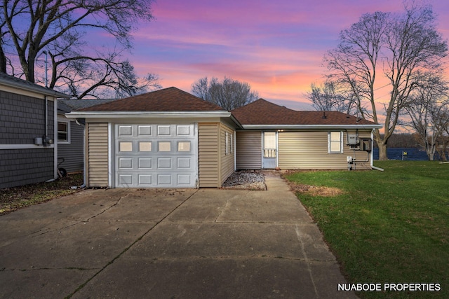 single story home featuring driveway, a shingled roof, and a front lawn