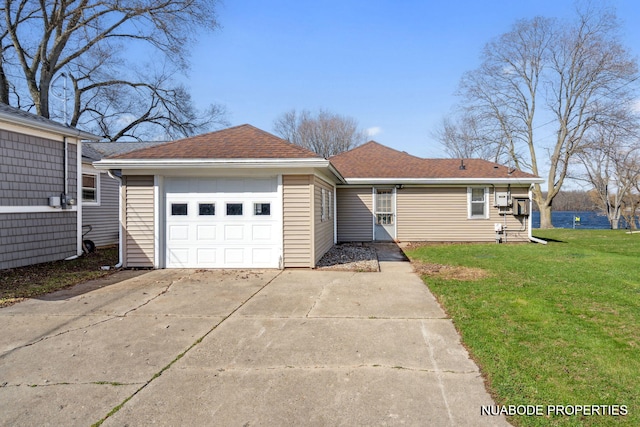 ranch-style house featuring a front lawn, roof with shingles, a garage, and concrete driveway